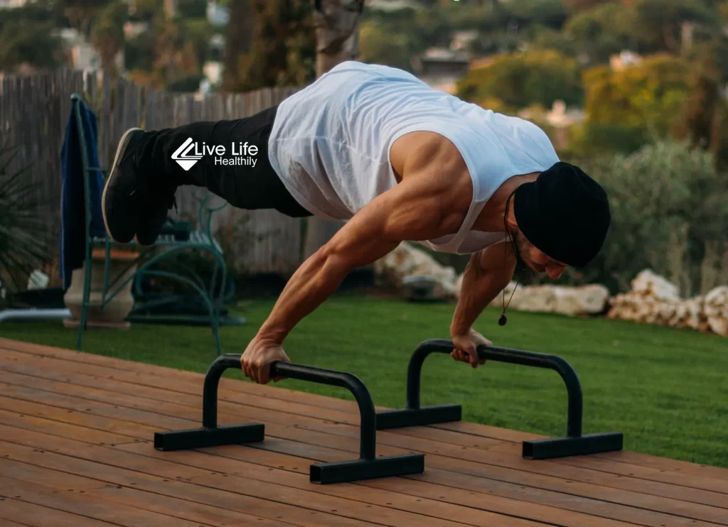 man doing dip bar exercises on parallettes