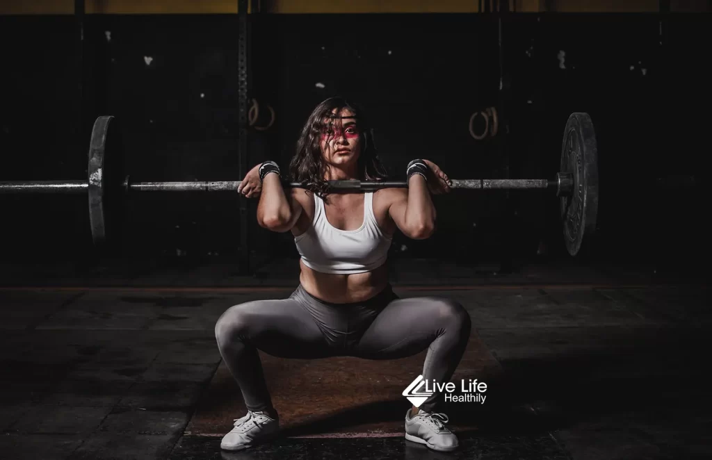 sqaut variations - woman doing barbell front squat - compound leg exercises